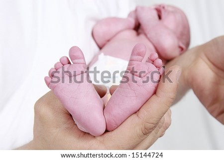 babies feet taken closeup with father