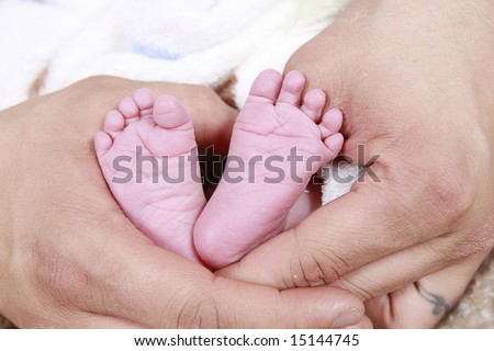 babies feet taken closeup in Father's hands