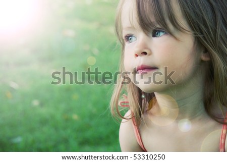 Adorable little girl taken closeup outdoors in summer lighting effect Adorable little girl taken closeup outdoors in summer lighting effect