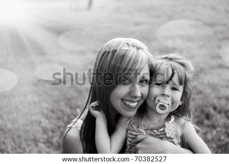 Young mother with child outside on a summer day.Black and white