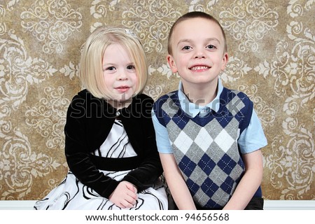 Adorable little brother and Sister on studio background