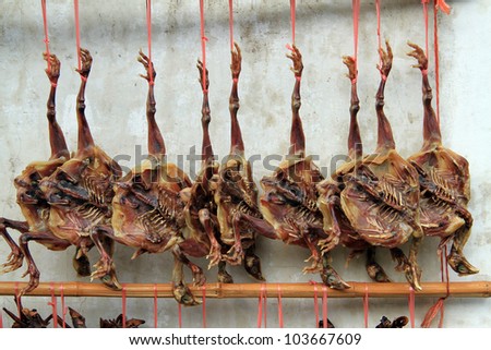 Smoked chikens near the wall in chinese village