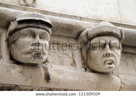 Two heads on the wall of cathedral in Shibenik, Croatia