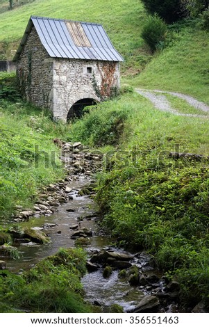 Stone mill and small river near Pyrenee mountain, France