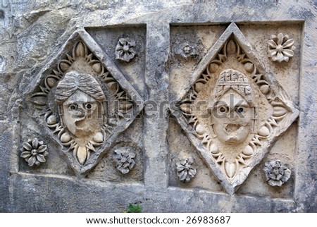Two stone masks on the stage in theater, Myra, Turkey