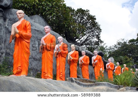 Rock and long line of monks in Dambulla, Sri Lanka