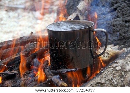 Wood and boiling water in big campfire