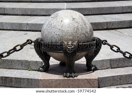 Marble ball and bronze chain near the monument