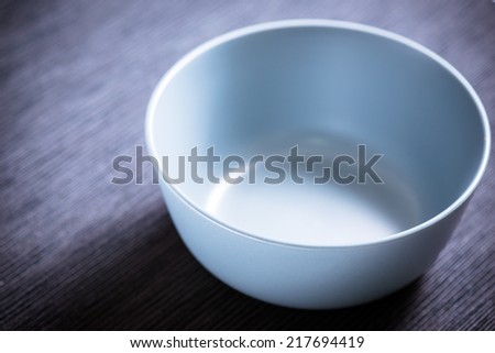 Blue empty bowl on black background