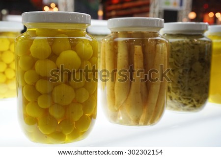 Variety of colorful canned vegetables in glass pot. Food, preserve concept.
