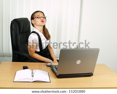 attractive office woman giving a kiss to the viewer
