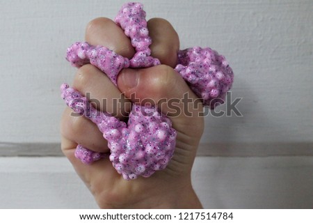 slime with foam beads that is satisfying to touch and squeeze with your fingers and hands while your dad takes pictures