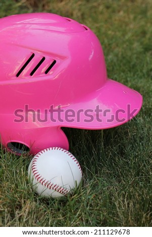 pink baseball helmet and ball