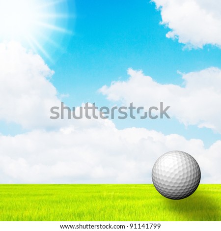 golf ball in green grass on a blue sky and sun