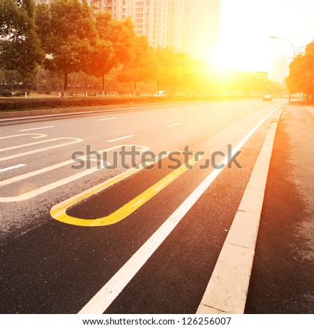 road in city with sunset