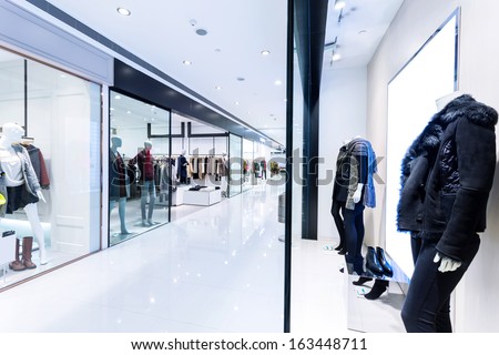 Boutique Display Window With Mannequins In Fashionable Dresses