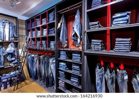 Jeans shirts at shelf in shop