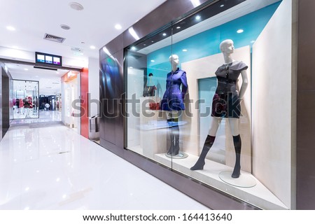Boutique Display Window With Mannequins In Fashionable Dresses