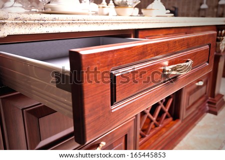 wooden cupboard with opened empty drawer