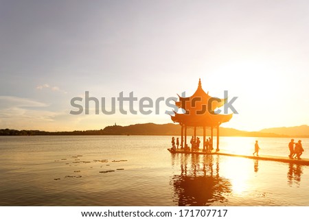 ancient pavilion in hangzhou with sunset glow