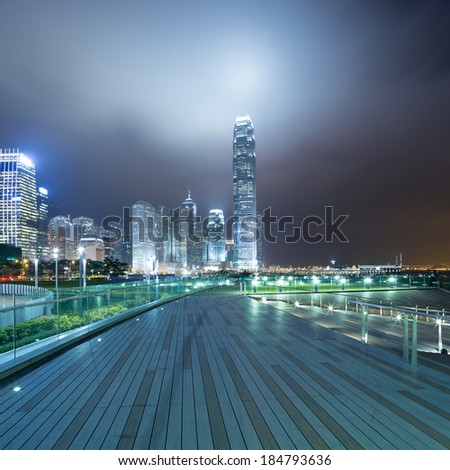 pathway in the night with modern city background