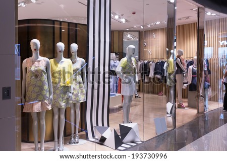 Boutique display window with mannequins in fashionable dresses