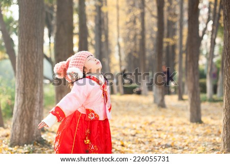 little girl dress new year  costume and enjoy outdoor  in forest