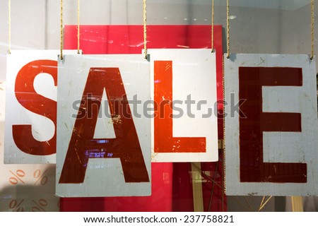 clothes storefront window with sale poster