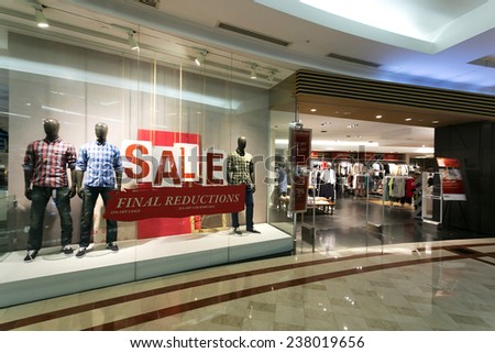 clothes storefront window with sale poster