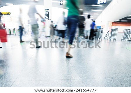 passengers walking in rush hour at subway station