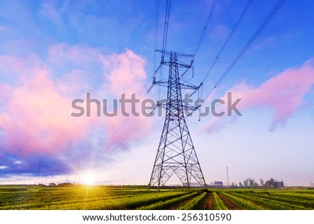 high voltage pylon in field with skyline