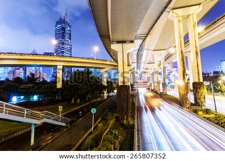 traffic trails on elevated road in modern city