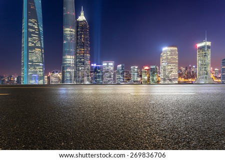 urban road,illuminated skyline background