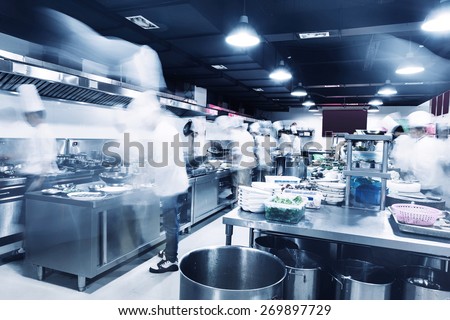 modern kitchen and chefs in hotel