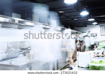 modern kitchen and busy chefs of hotel