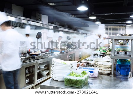 modern kitchen and busy chefs of hotel