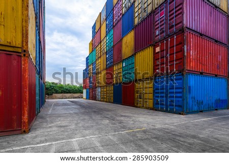 stack of containers with empty cement road in its front.