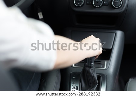 hand holding gear in car