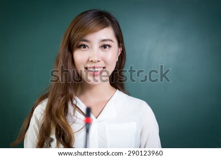 Asian beautiful woman speaking in front of blackboard with microphone.