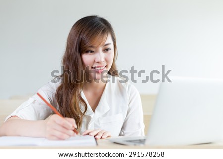 Asian  beautiful female student study with laptop in classroom