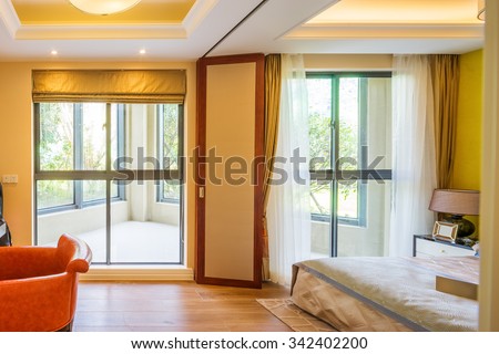 interior of bedroom with balcony in modern villa