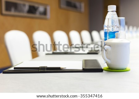 big oval meeting table and white board in modern meeting room