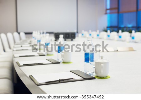 big oval meeting table and white board in modern meeting room