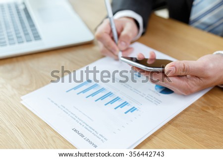 business man checking financial reports on table using computer,digital tablet and mobile phone