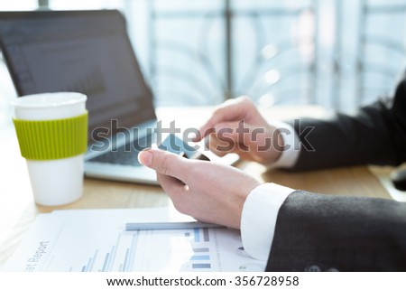 business man checking finance report on table by using laptop,tablet and mobile phone