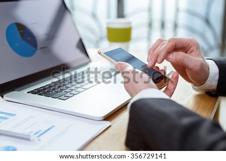 business man checking finance report on table by using laptop,tablet and mobile phone