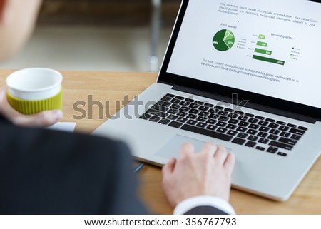 businessman checking financial report on table by using laptop,tablet and mobile phone