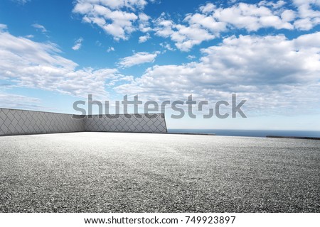 empty asphalt road and beautiful sea in blue cloud sky
