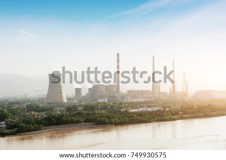 power plant along long river under sunshine