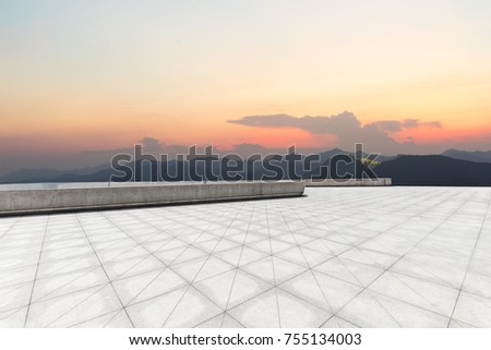 empty marble floor and green mountains in colorful cloud sky at twilight